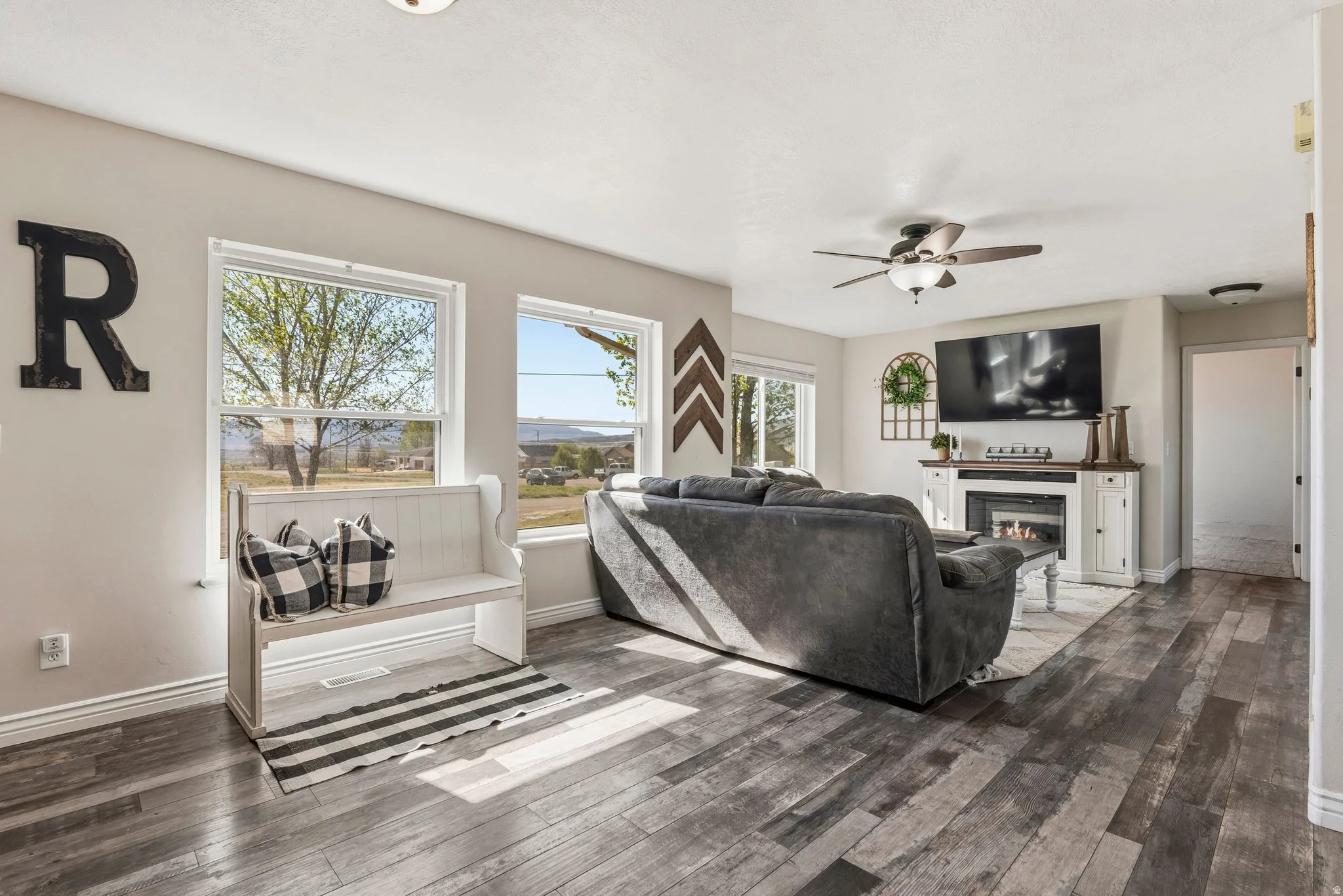 Bright Utah living room with a fireplace, large windows, and mountain views