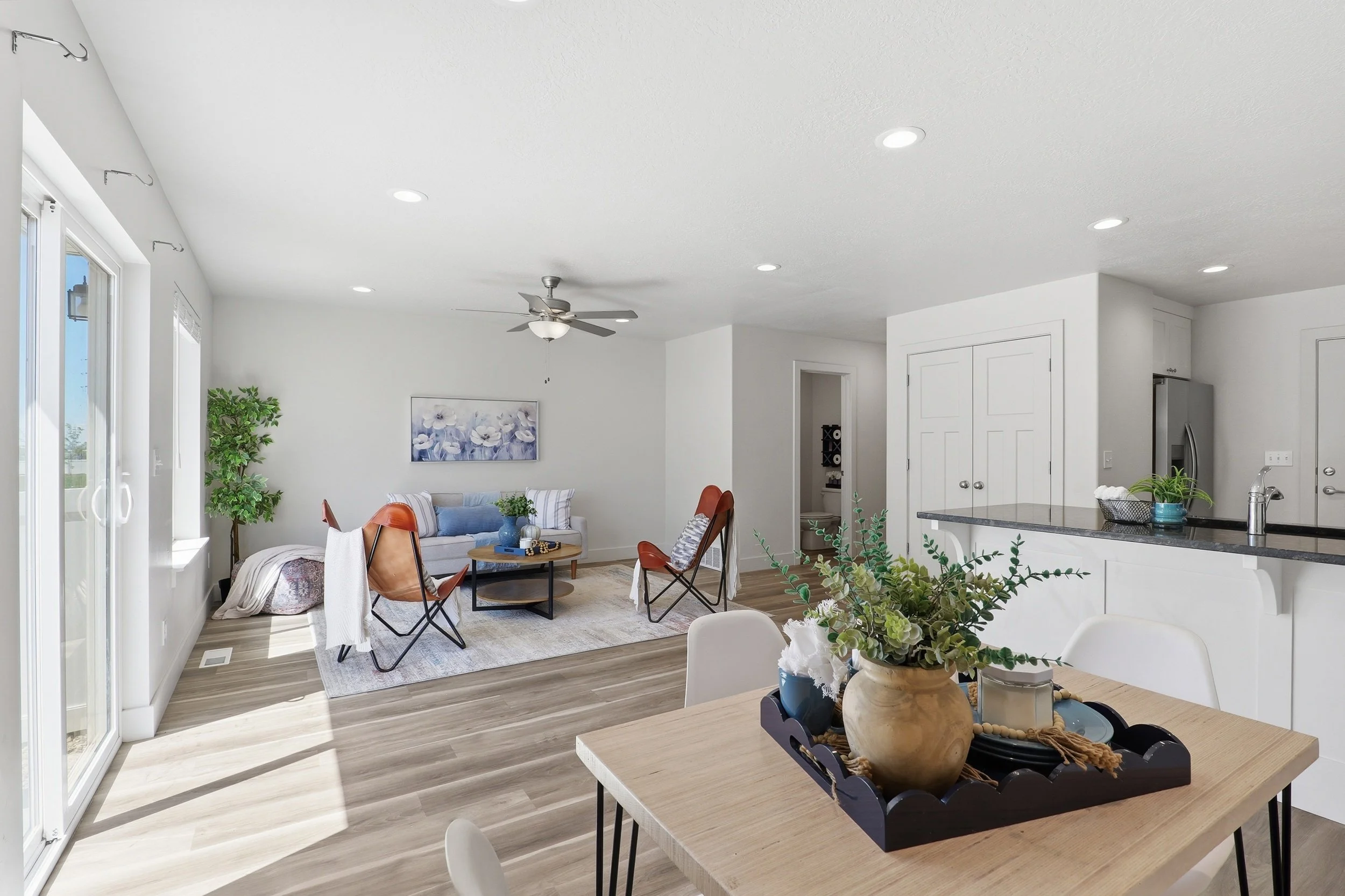 Bright open concept dining, kitchen, and living space representing the financial and lifestyle value of homeownership