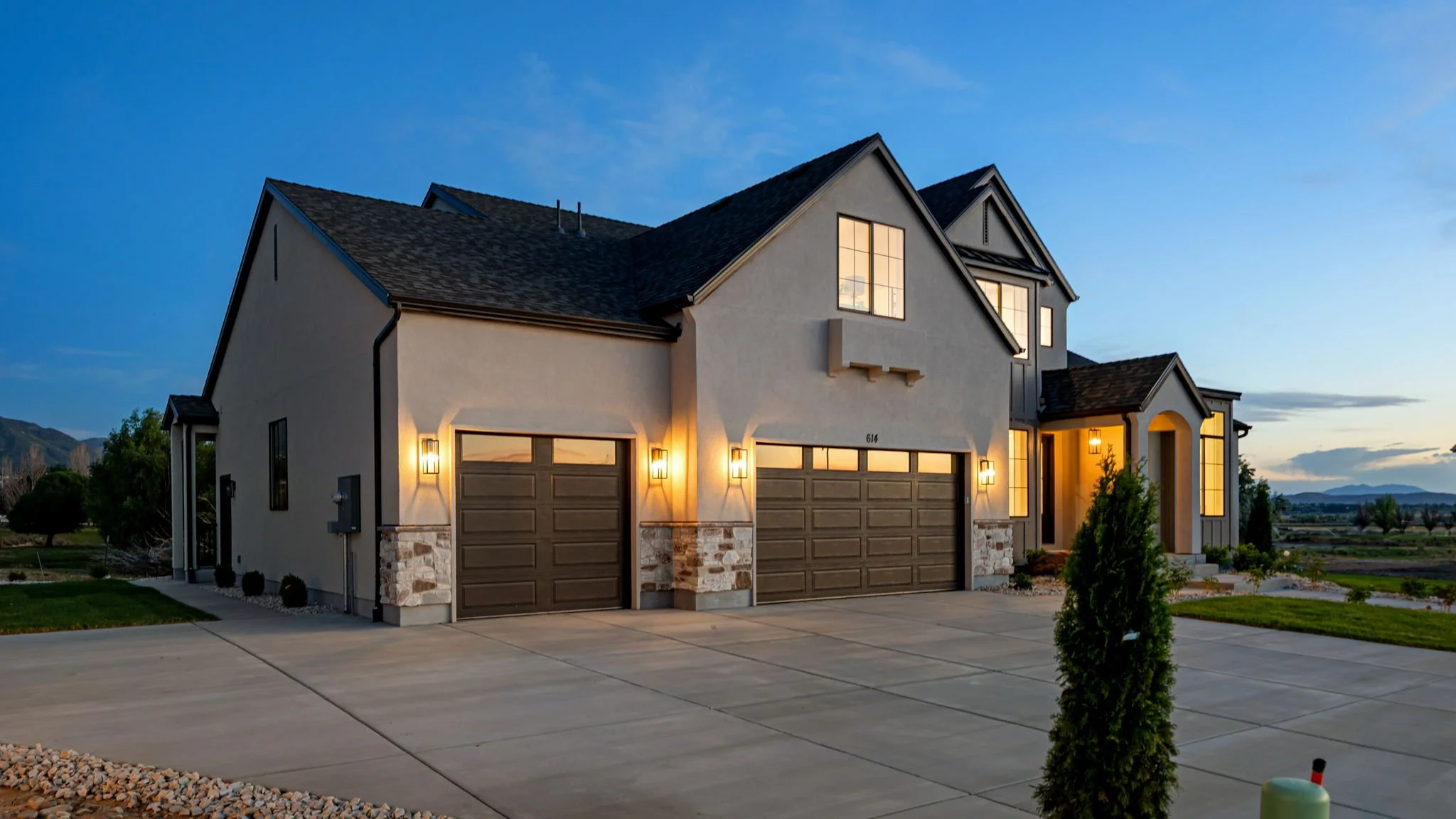 Luxury home exterior at twilight with warm architectural lighting