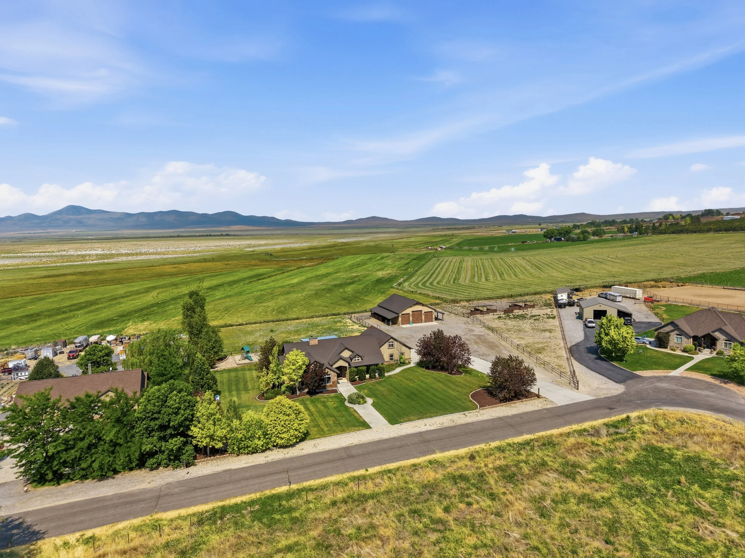 Aerial view of homes on large lots between fields in Genola Utah