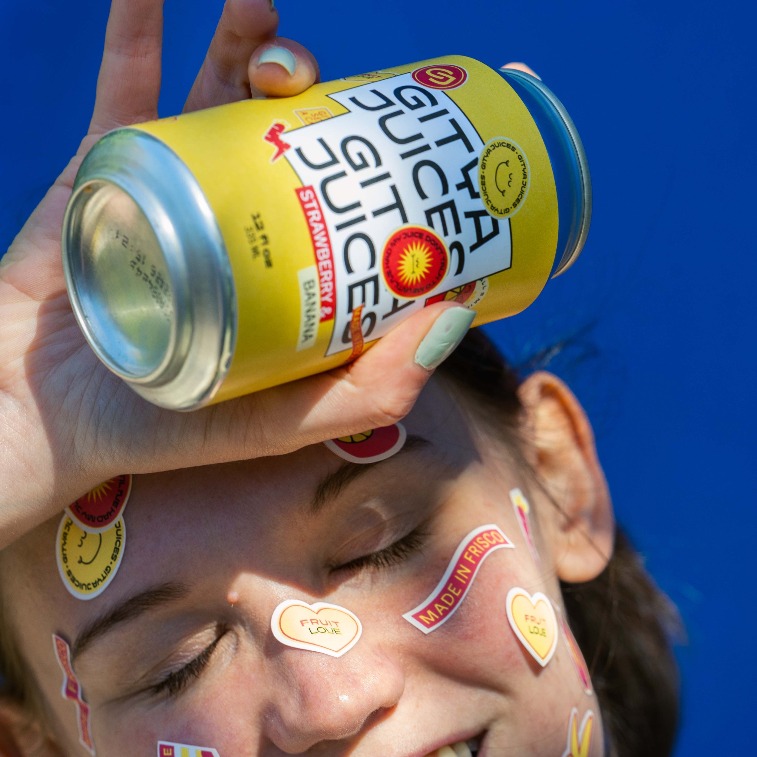 Product Photography of a woman holding a can of Gitya Juices