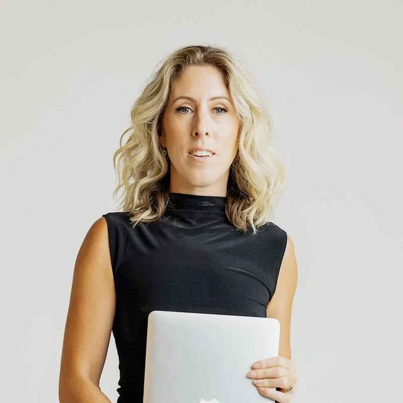 Portrait of Meghan Lee holding a laptop