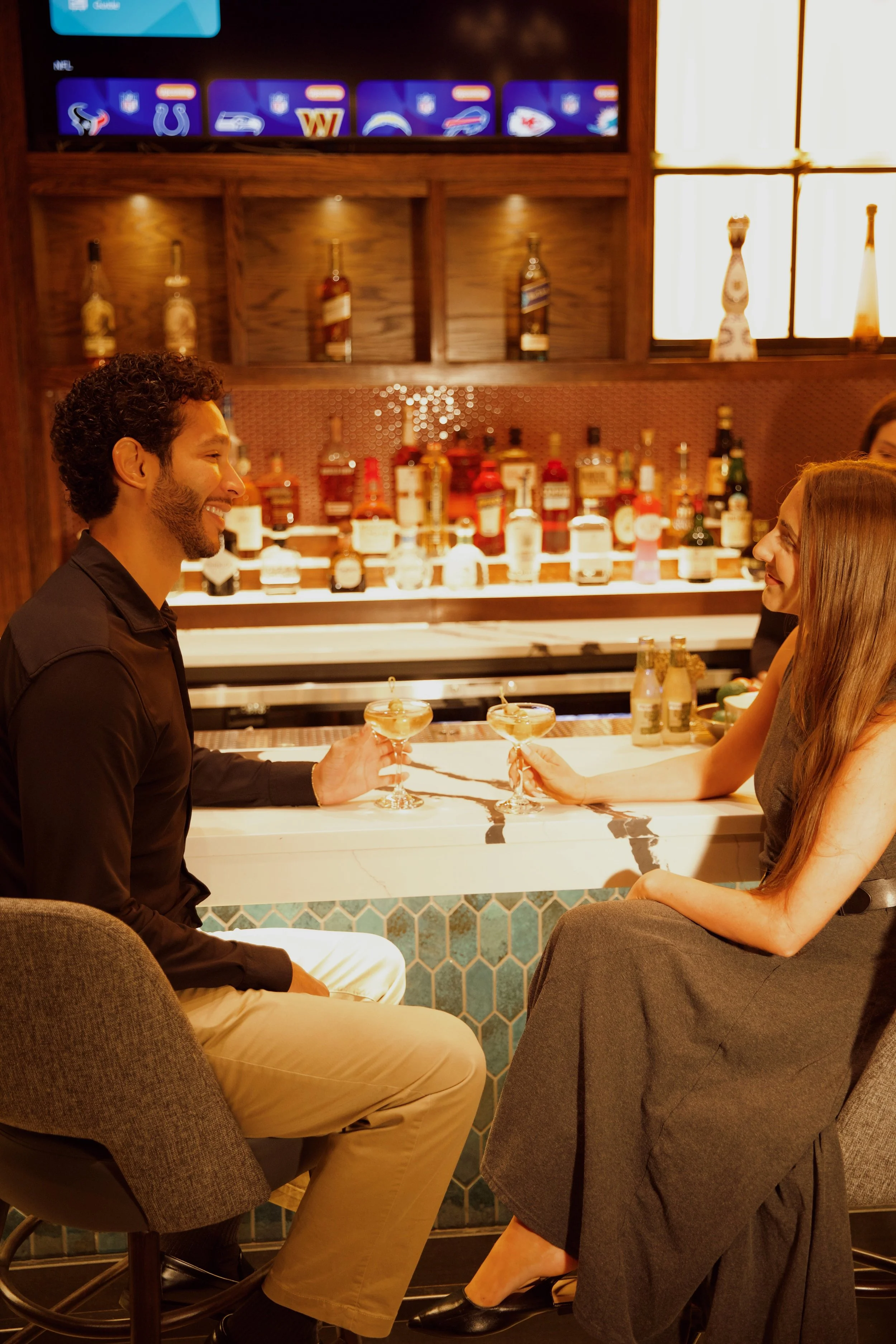 A couple enjoying cocktails at Penny’s Bar