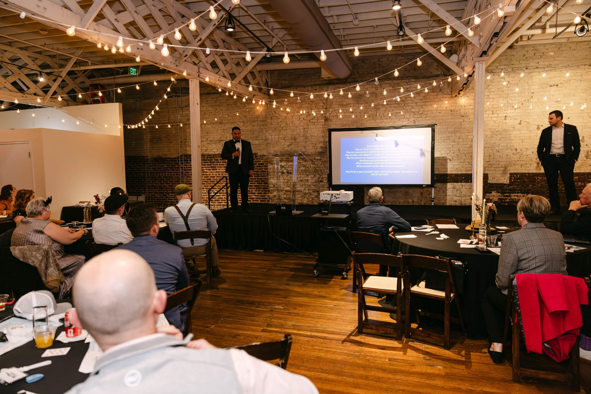 Corporate event audience listening to an on-stage speaker