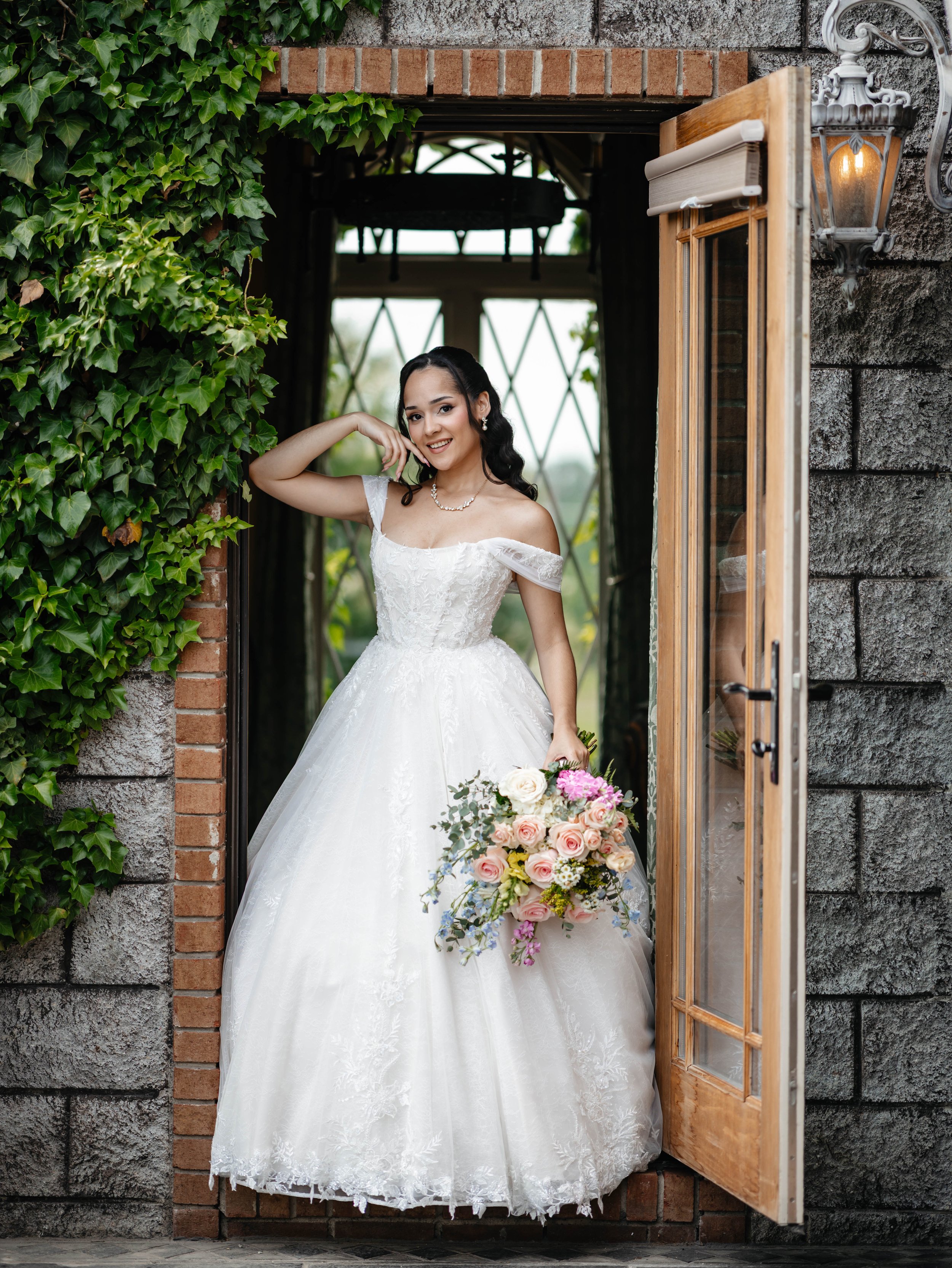 Bride photographed in an ivy-framed doorway