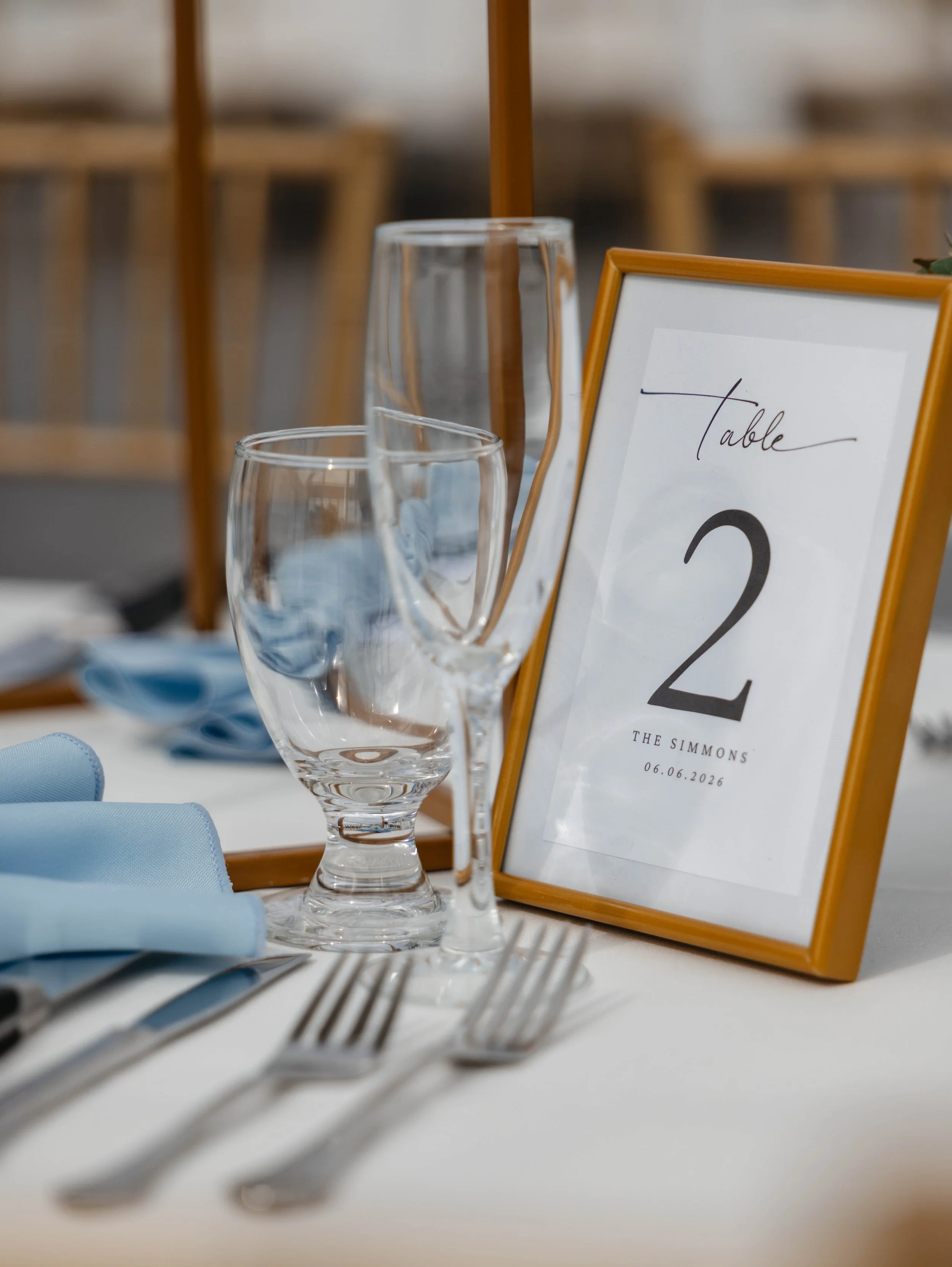 Wedding table number framed by polished floral details