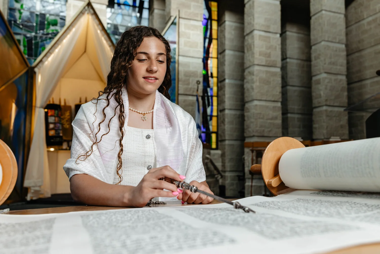 Lexie reading from the Torah during her Bat Mitzvah