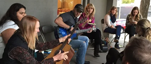 Songwriters sharing songs on a porch