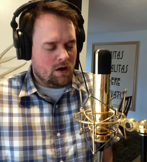 Singer recording a vocal overdub in headphones