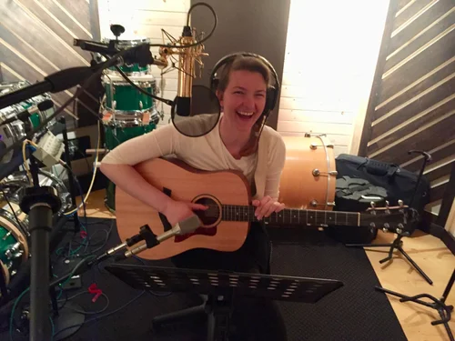 Guitarist laughing during a recording session
