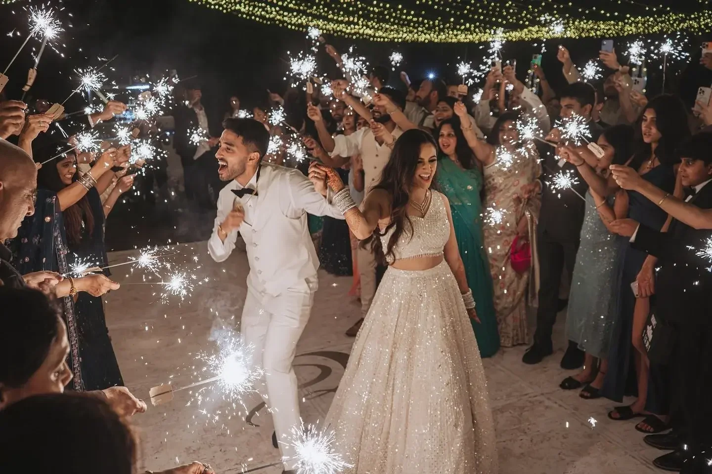 Couple celebrating with sparklers at their wedding