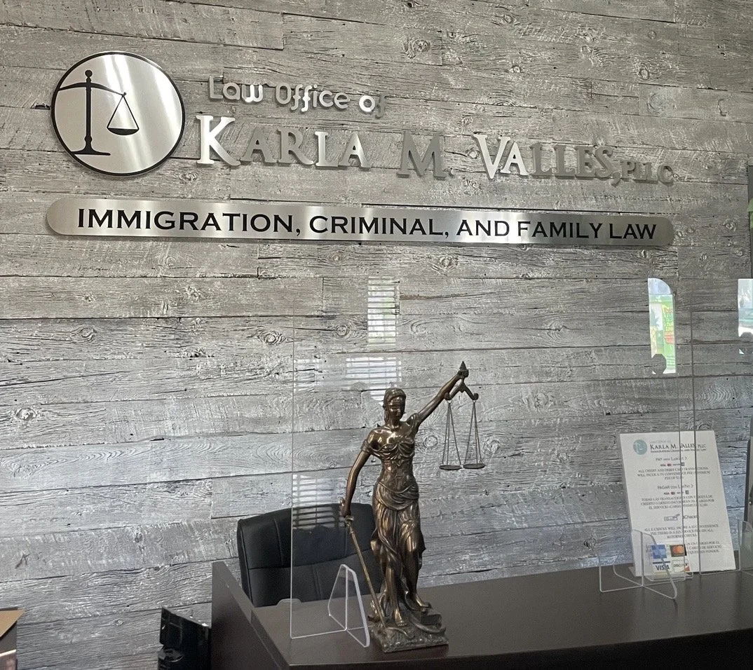 Reception area, with the firm signage and Lady Justice statue
