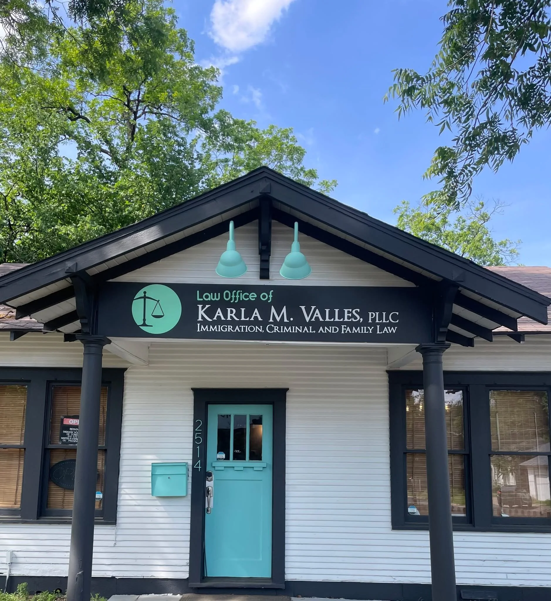 Law Office of Karla M. Vallés exterior with turquoise door and firm signage