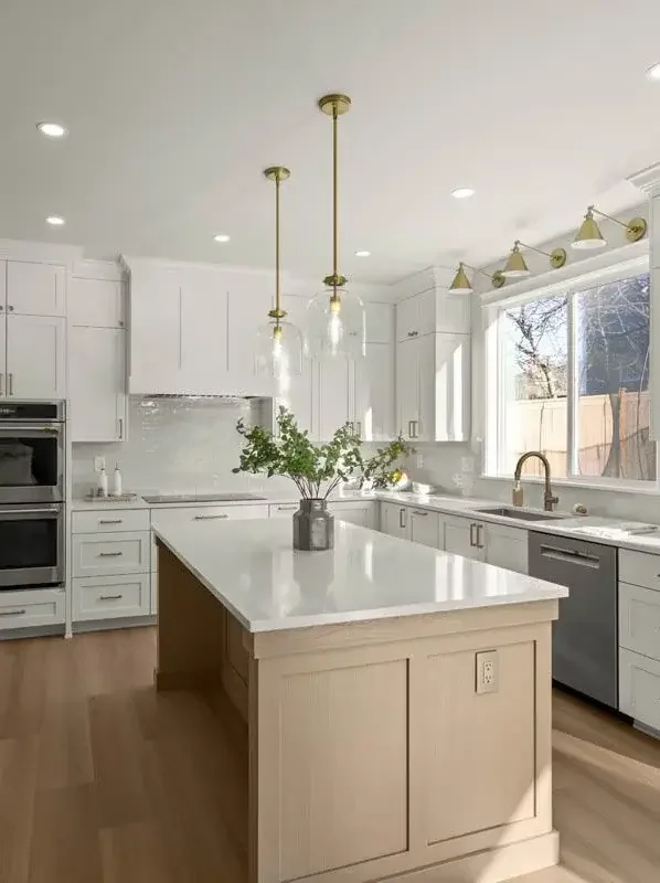 Custom Tacoma home remodel featuring a bright kitchen with white cabinetry and a large island