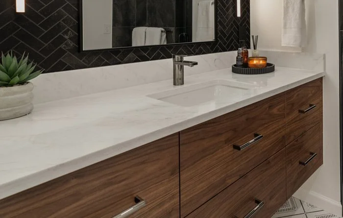 Custom bathroom vanity with warm wood cabinetry, long quartz countertop, and undermount sink for Tacoma WA bathroom remodel