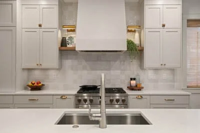 Custom range hood with white cabinetry in Bellevue kitchen renovation