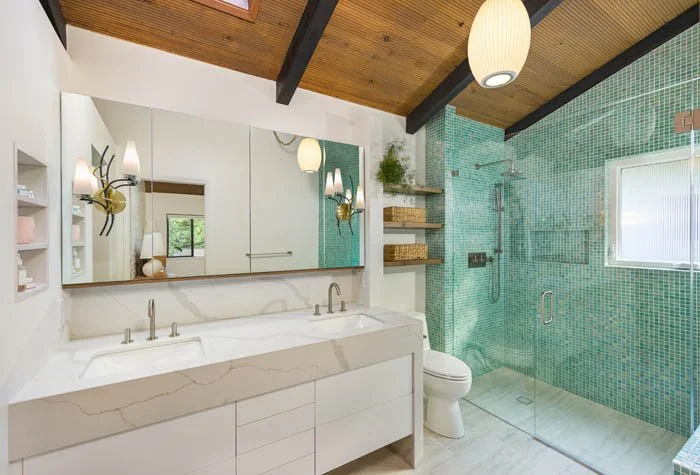 Mid-century primary bathroom remodel in University Place with curbless shower, floating vanity, and mosaic tile