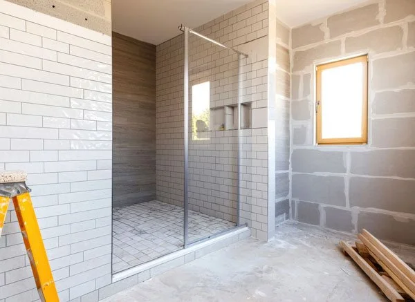 Bathroom expansion with new walk-in shower, glass panel, reconfigured layout and space planning for a Tacoma, WA remodel