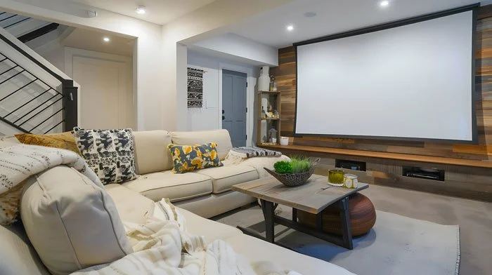 Basement media room with projector, acoustic wall panels, and dimmable lighting in Bellevue WA