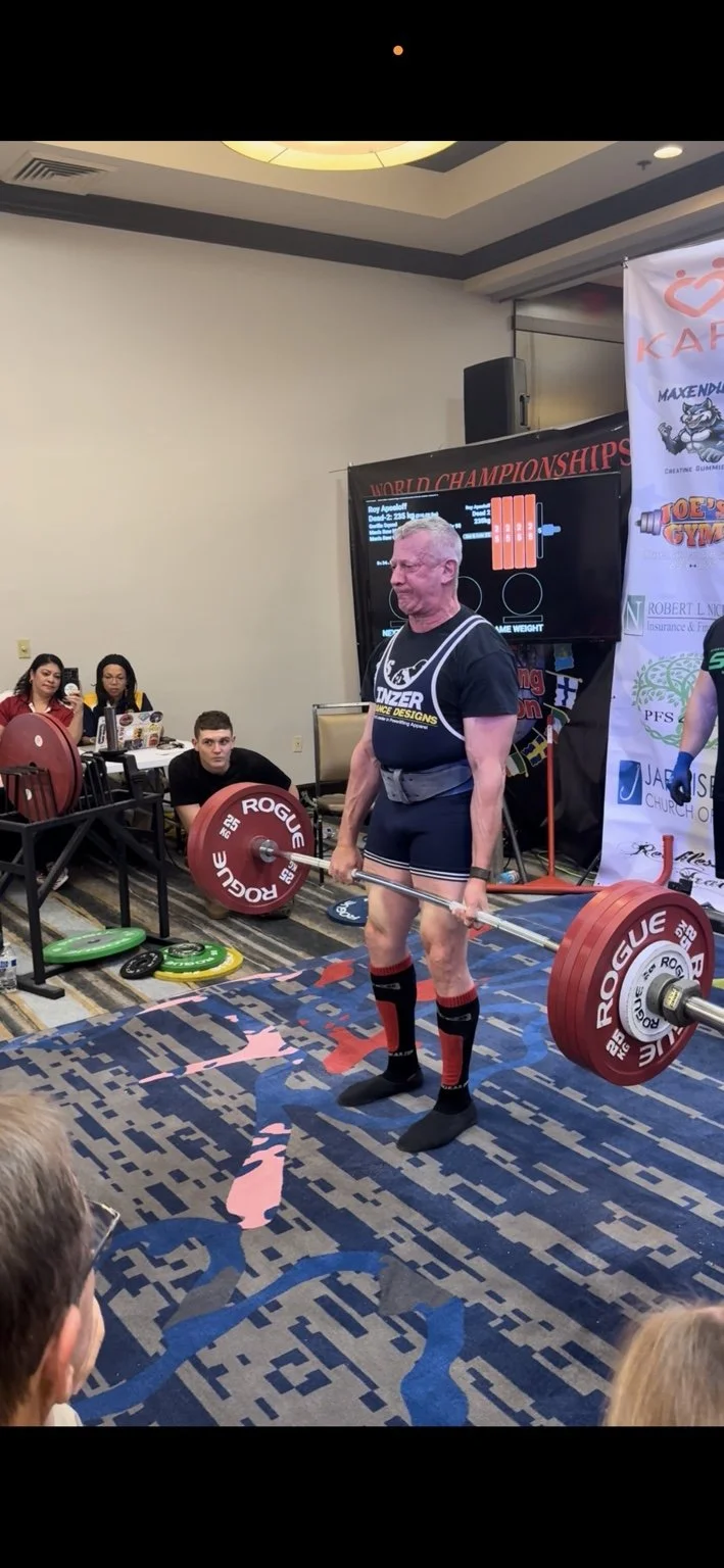Athlete deadlifting at a powerlifting competition