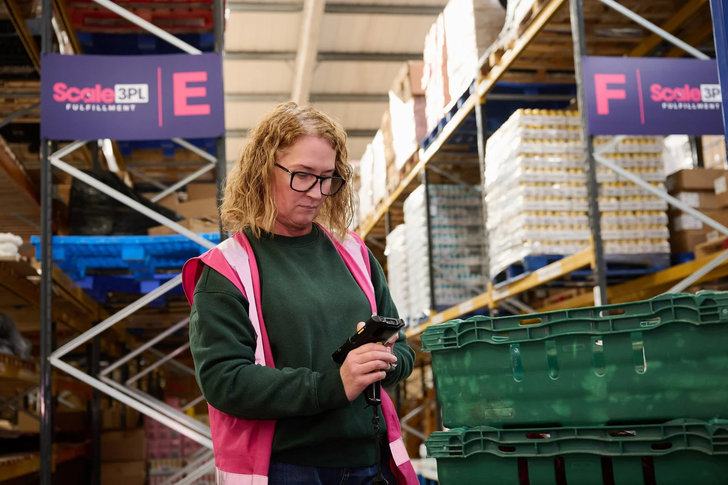 Scale 3PL warehouse team member picking an order from shelving