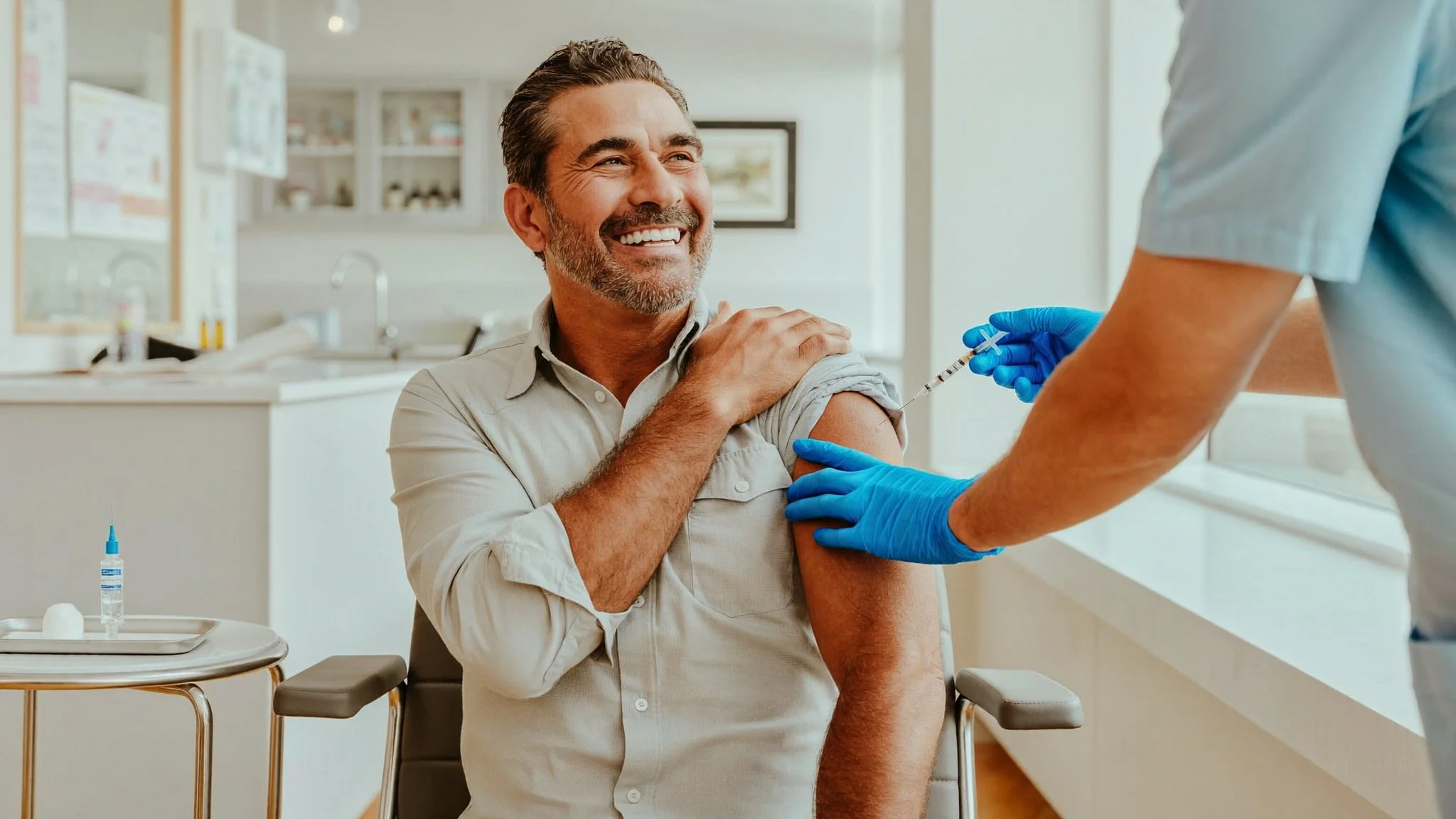 Flu shot McAllen TX, a Hispanic adult receiving a vaccination in the arm from a healthcare provider at a clinic in the Rio Grande Valley