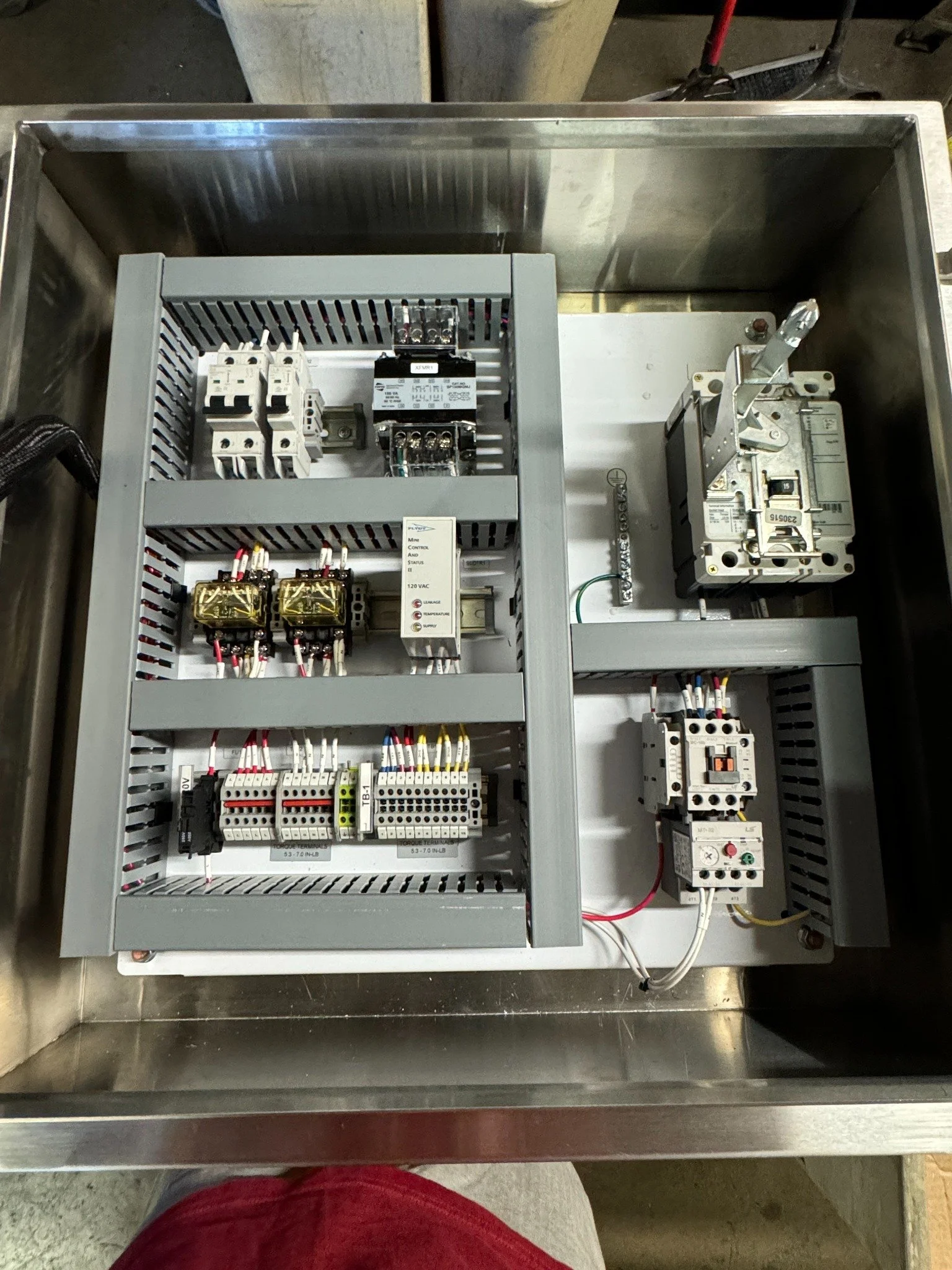 Internal motor control components and terminal wiring inside the sump pump panel
