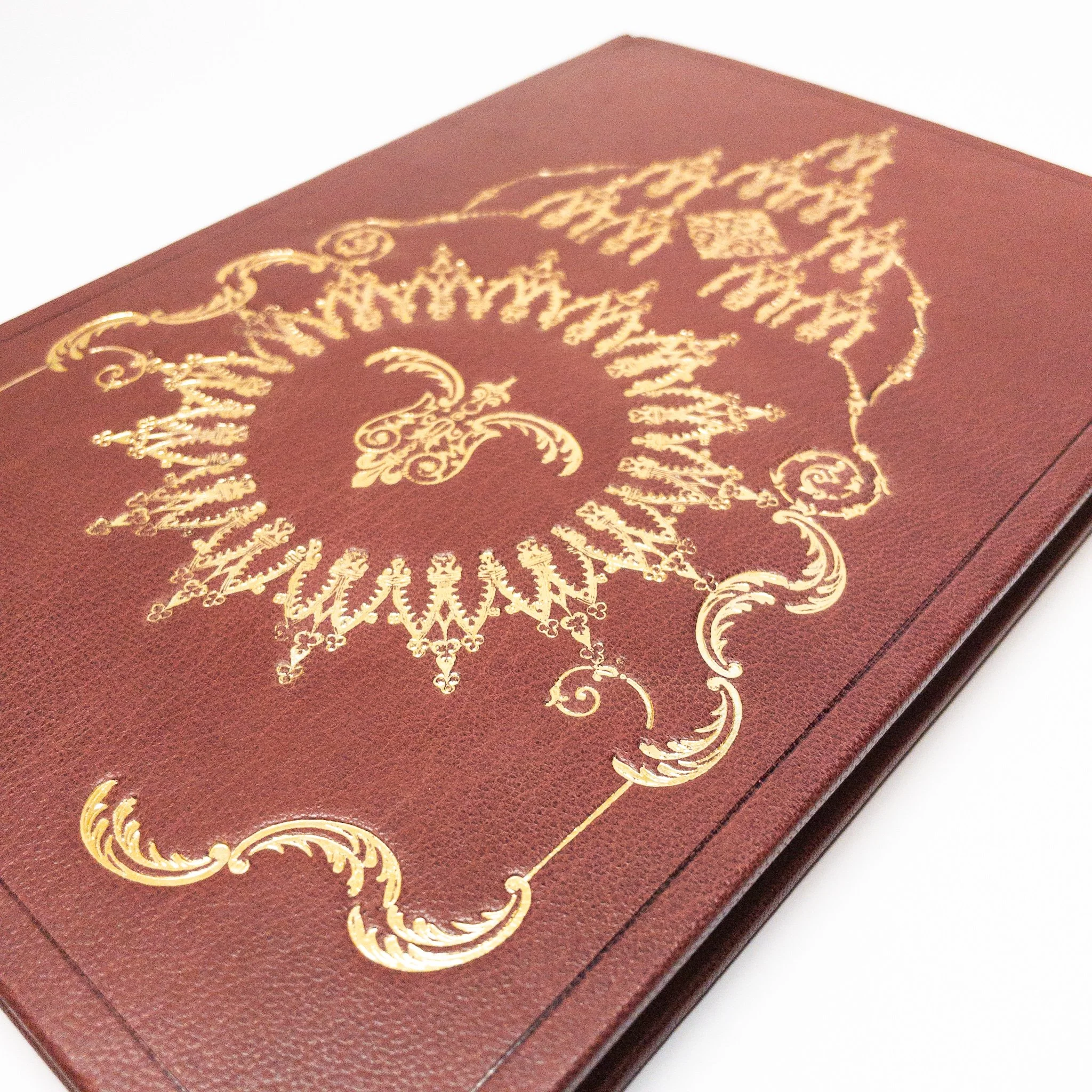 Gold tooling detail on burgundy leather