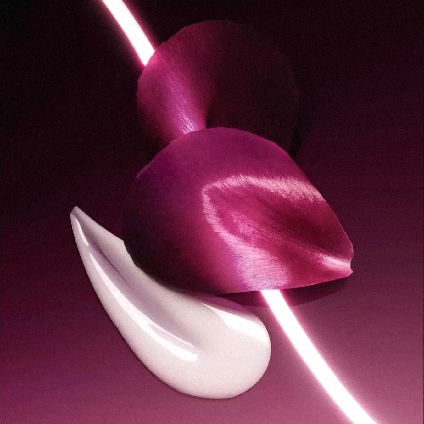 Capture Totale texture swatch with a rose petal