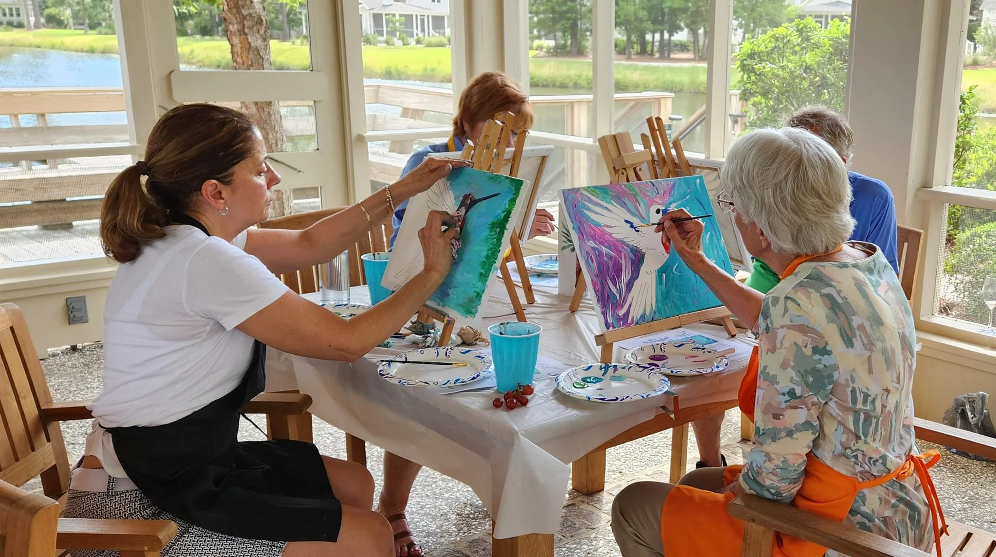 A vibrant hummingbird painting created at a Camilla workshop