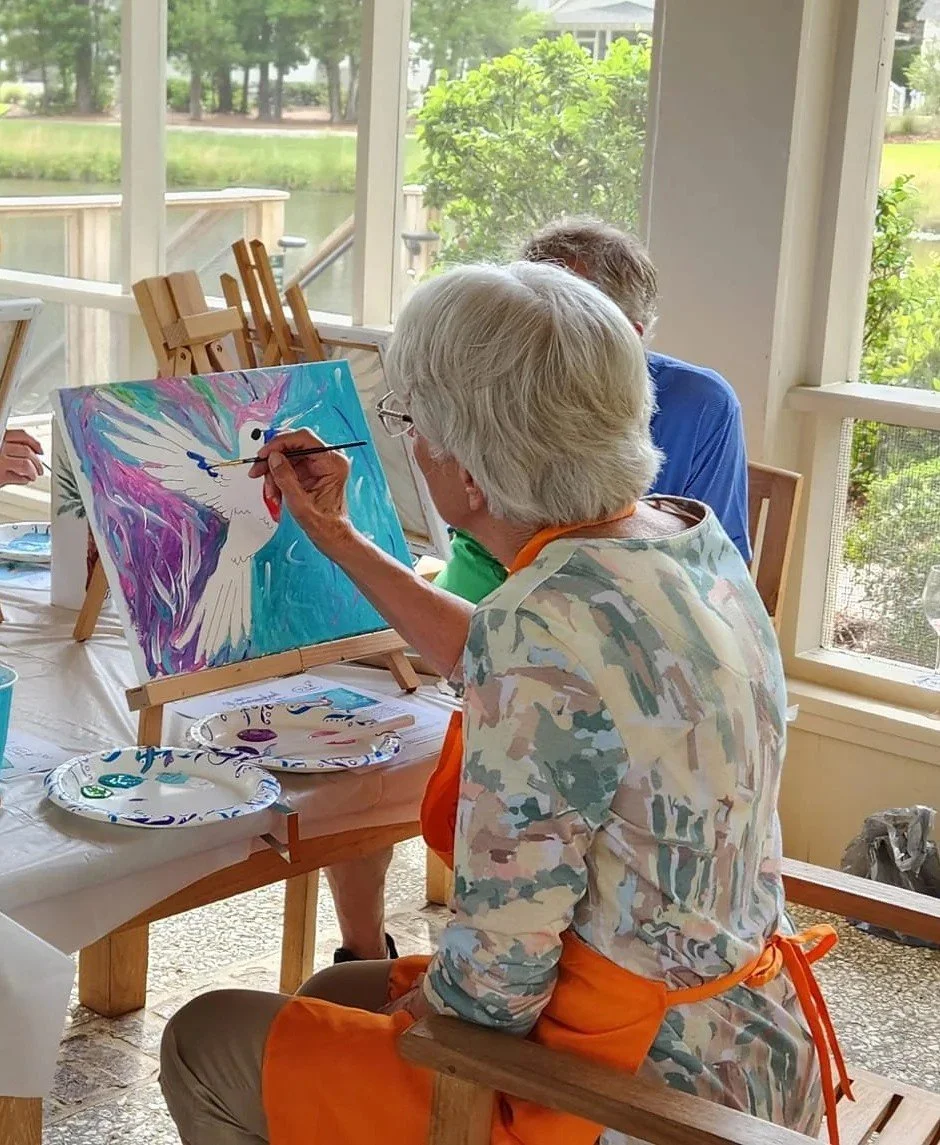 A vibrant hummingbird painting created at a Camilla workshop