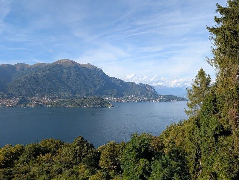 A peaceful European lake surrounded by mountains