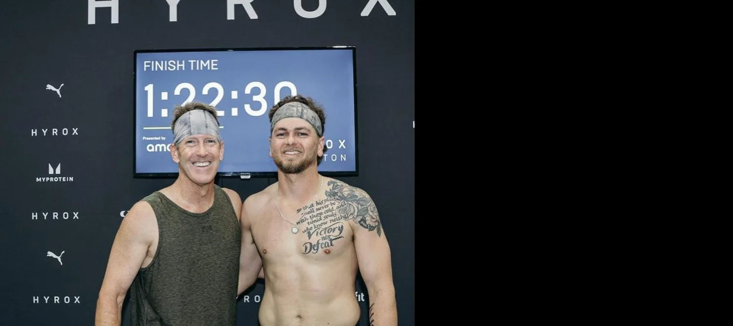Two Einhorn Training Co. members smiling at the HYROX Houston finish line