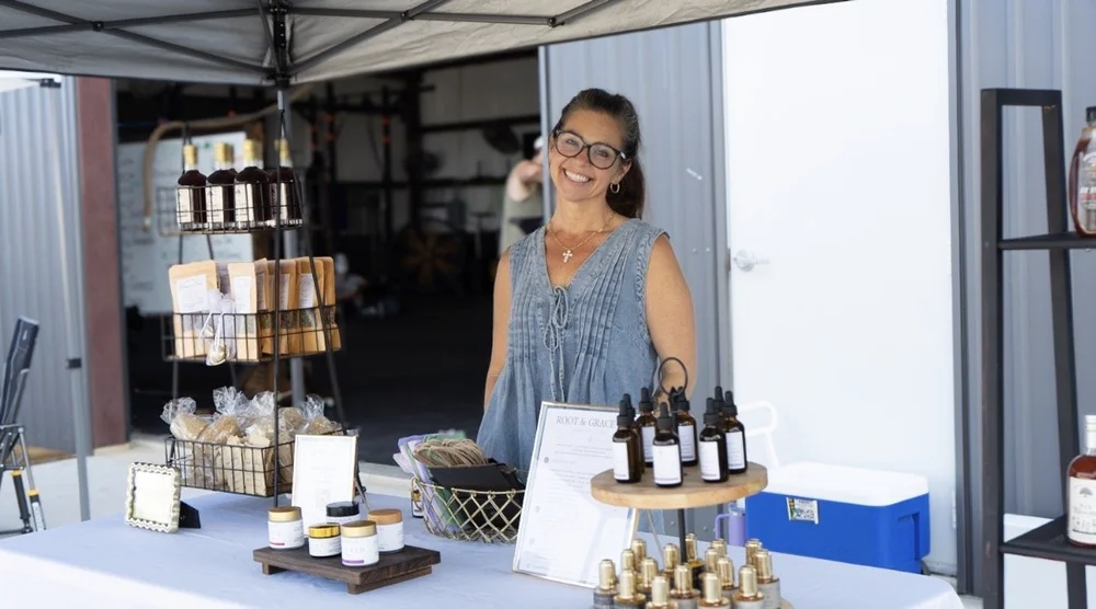 Local vendor smiling at her booth during the Einhorn Training Co. Movement Market in New Braunfels