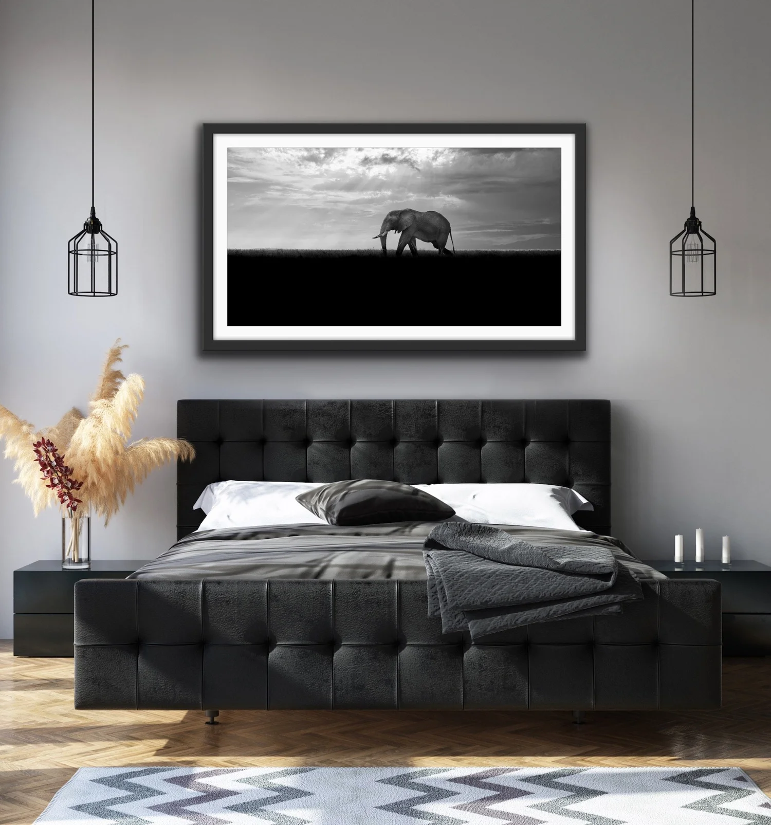 Framed black and white elephant photograph above a bed