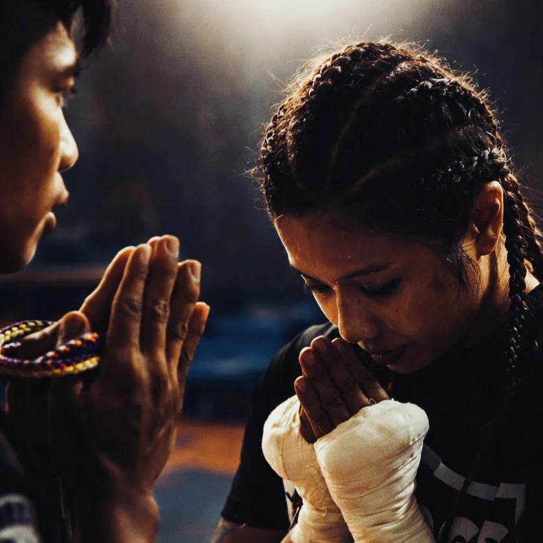 A boxer bowing with wrapped hands held together