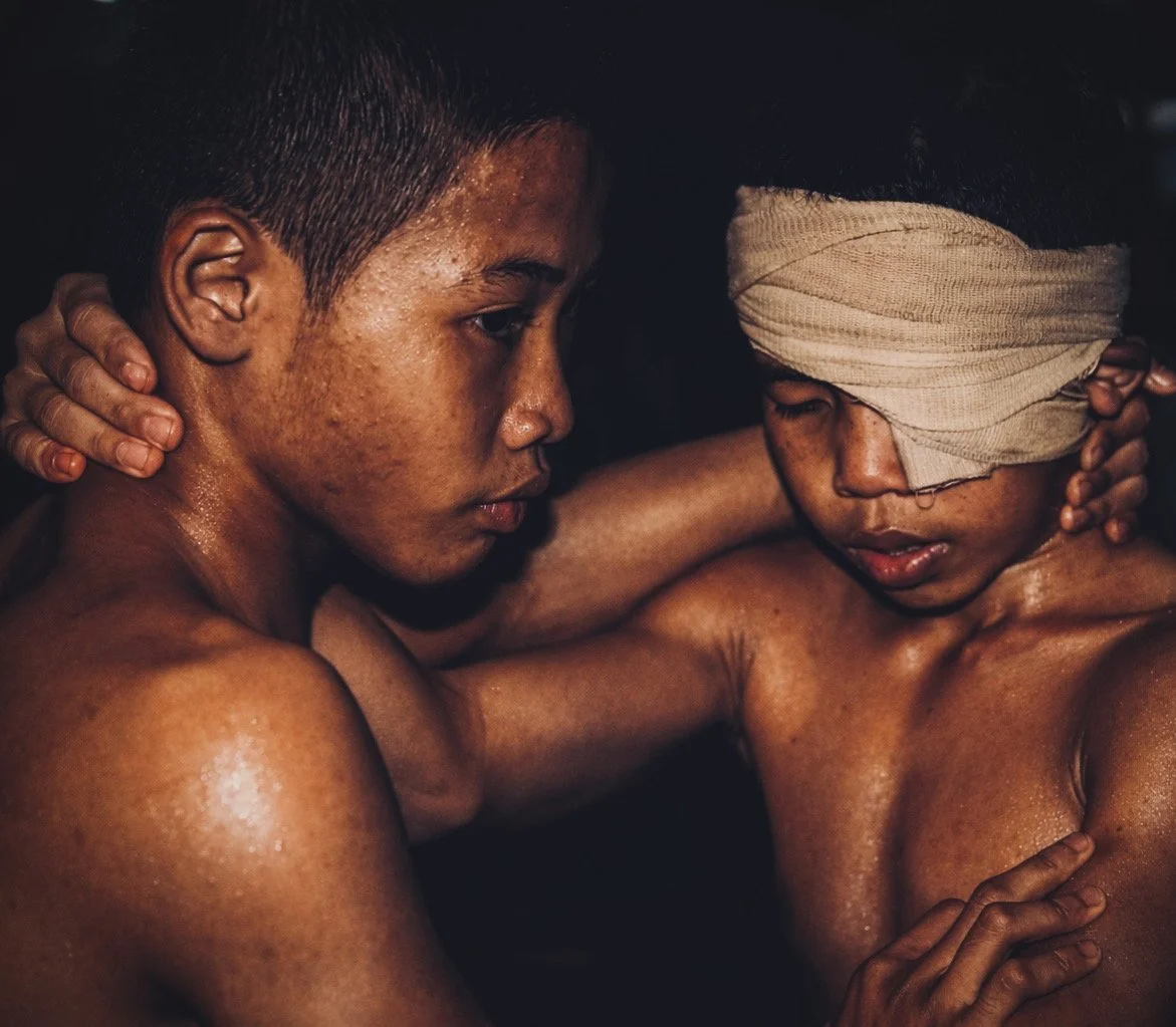 Two young boxers supporting one another after a bout