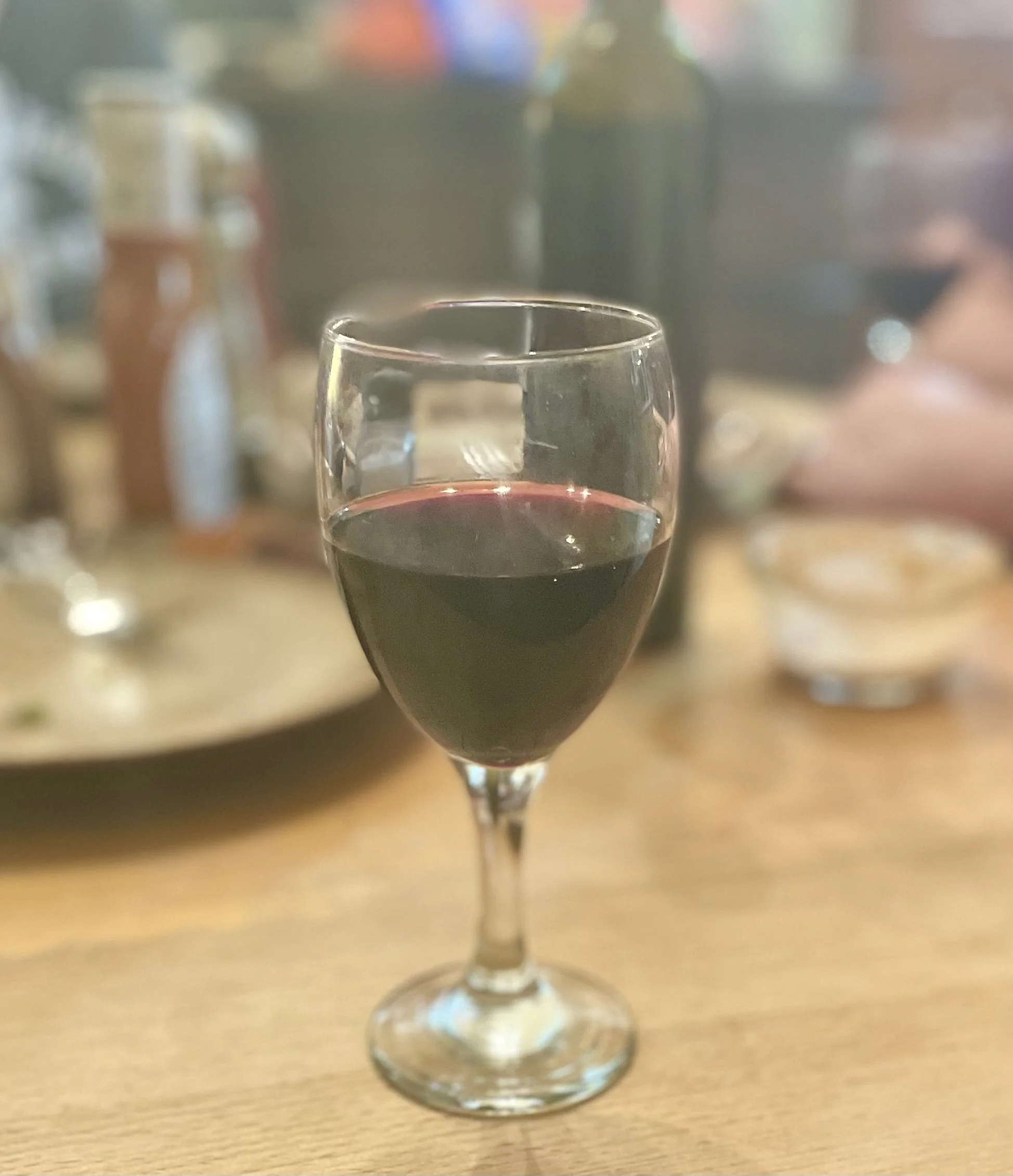 A glass of red wine on a table