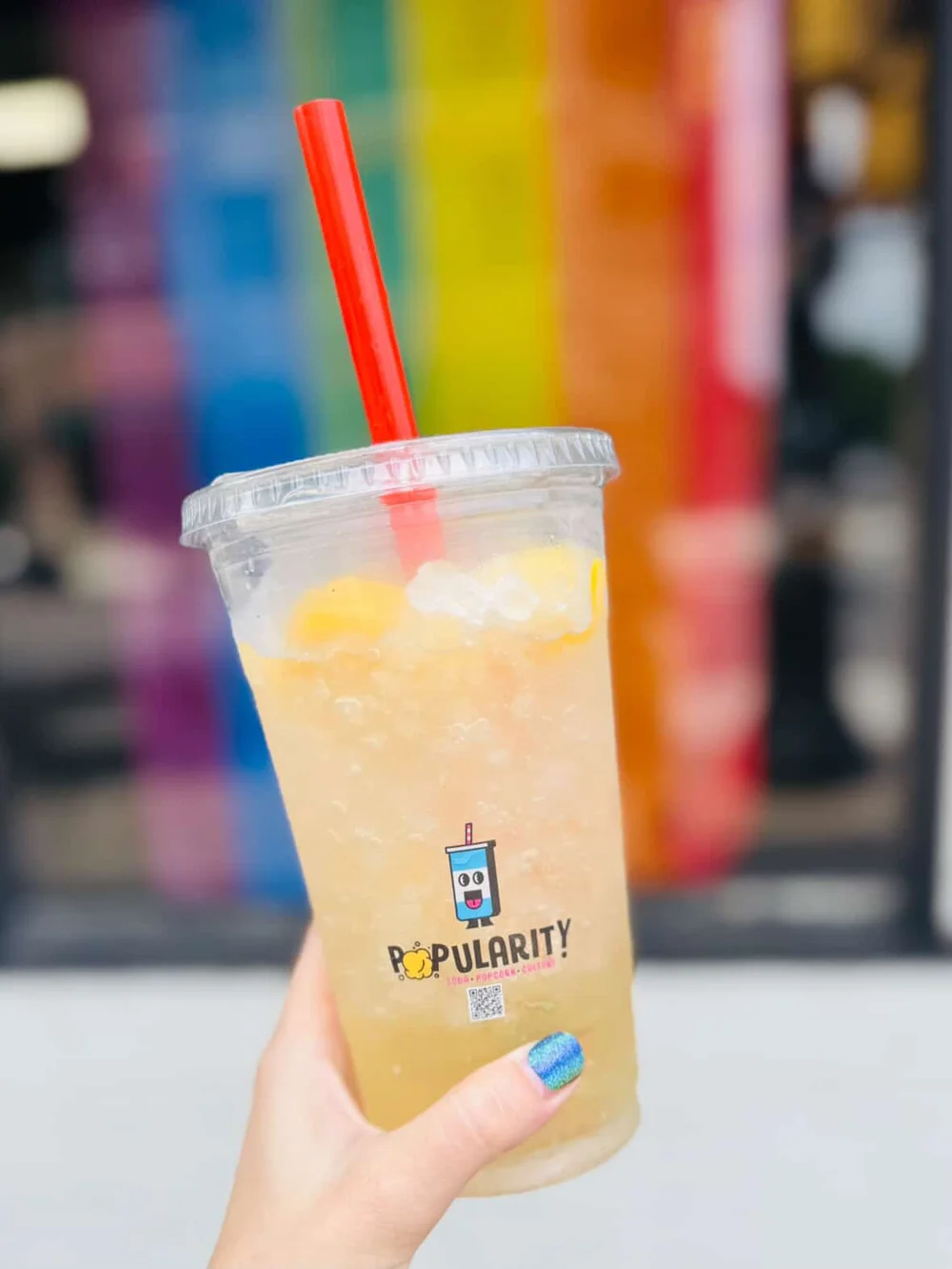 A hand-mixed dirty gourmet soda POP over ice in a branded POPularity! cup