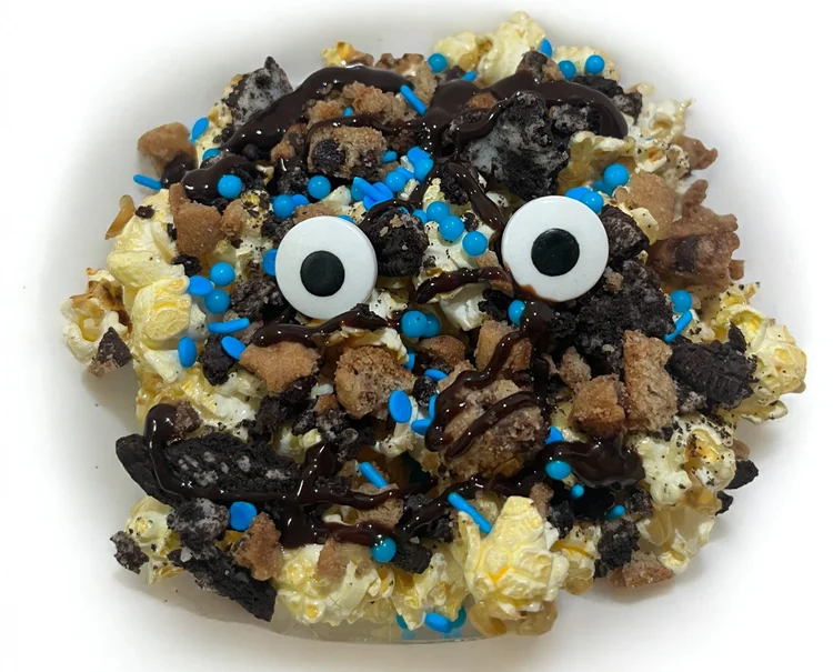 Cookie Monstah Dirty Loaded POPcorn with Oreo and Chips Ahoy pieces, chocolate sauce, blue sprinkles and candy eyes