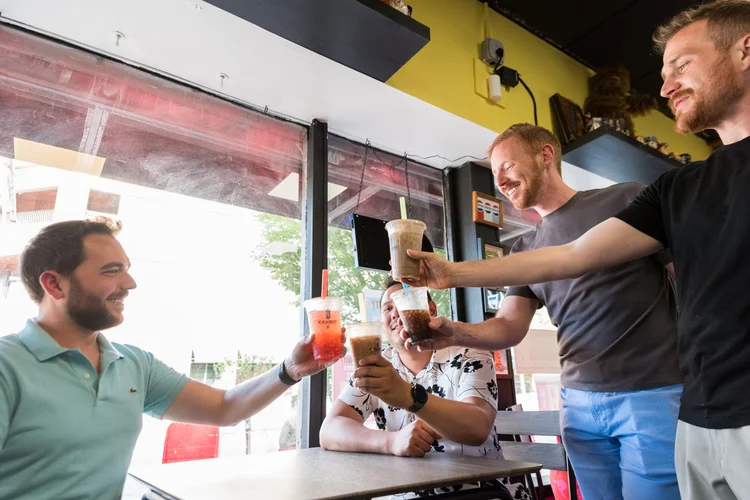 Guests raising four dirty gourmet soda POPs in a toast