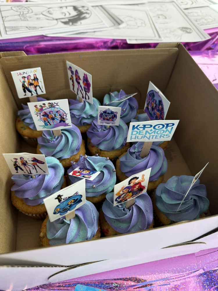 Themed cupcakes with custom toppers for a POPularity! party booking