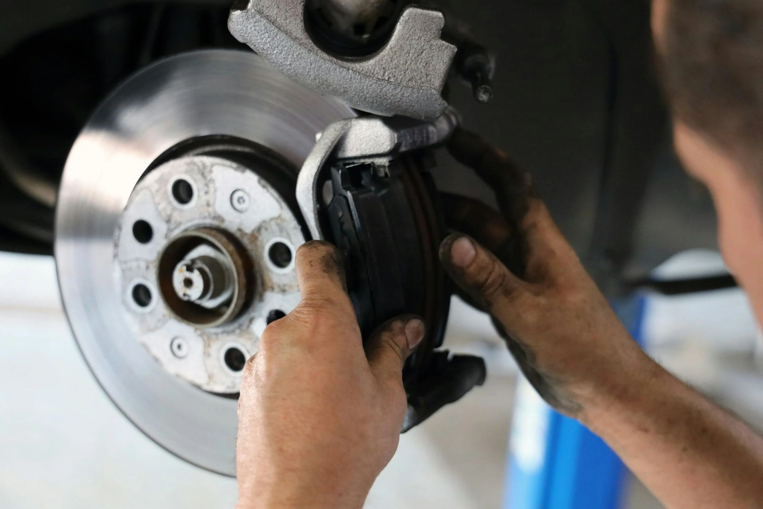 Technician measuring a brake pad