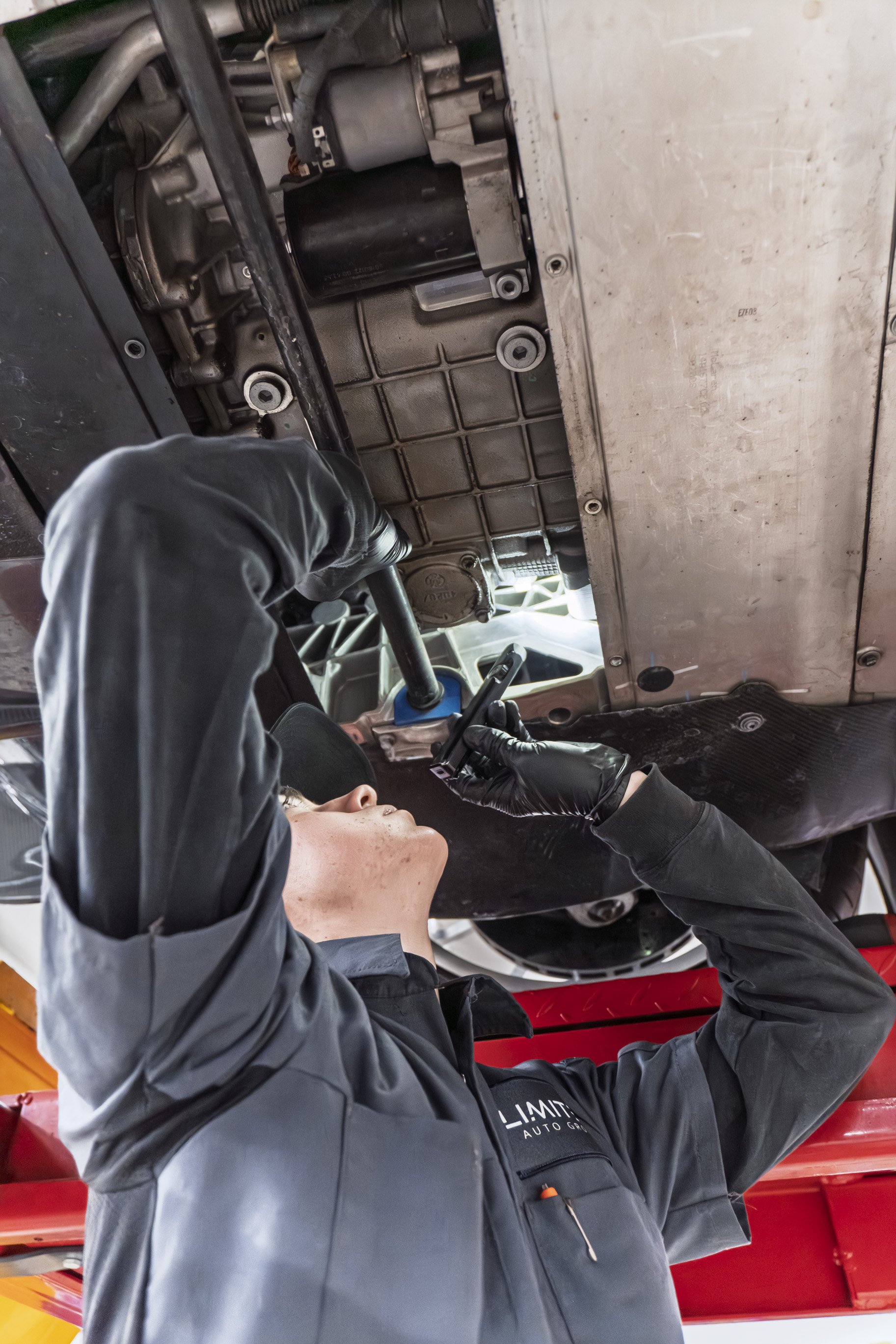Technician running diagnostics under the hood