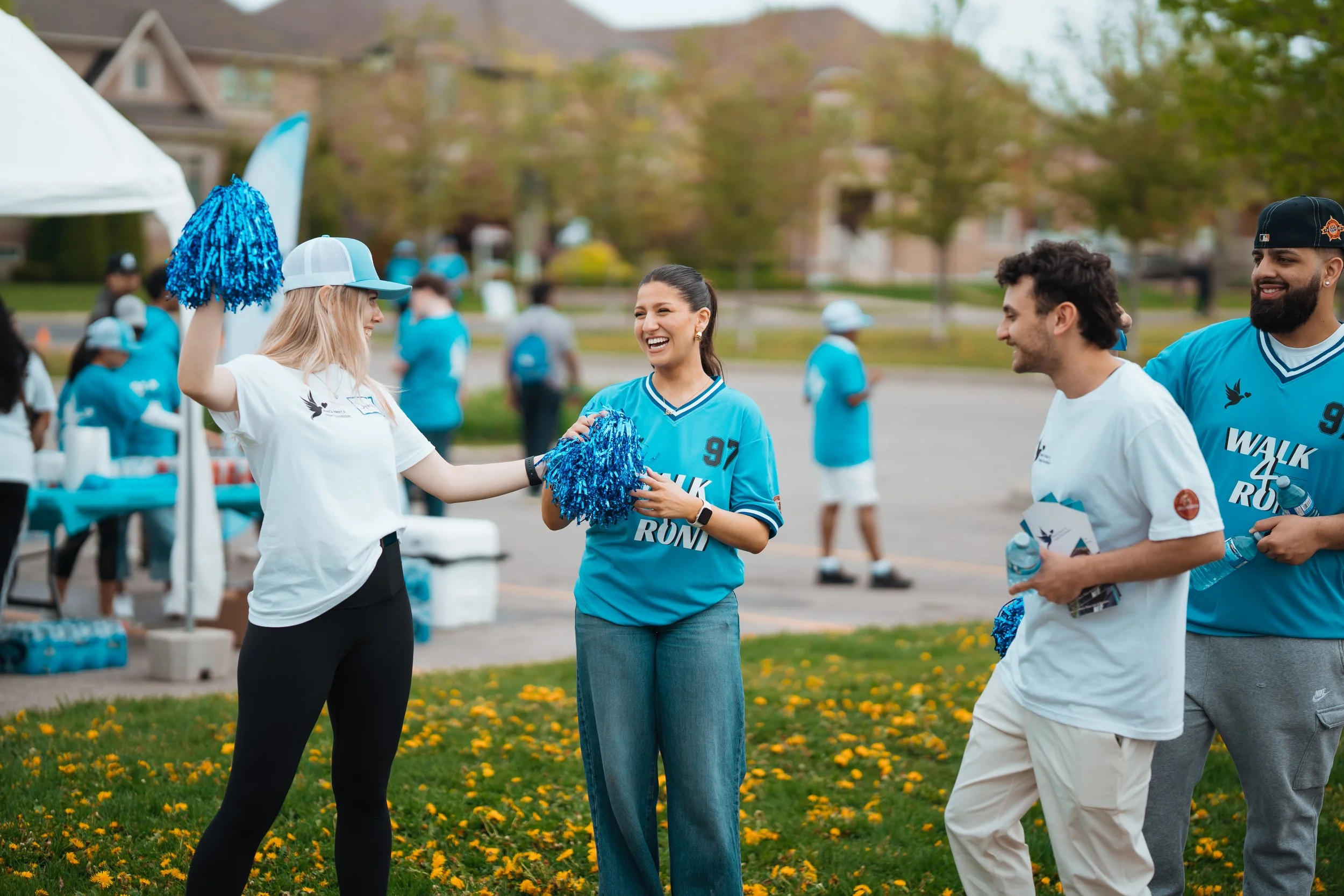 Volunteers with pom poms laughing