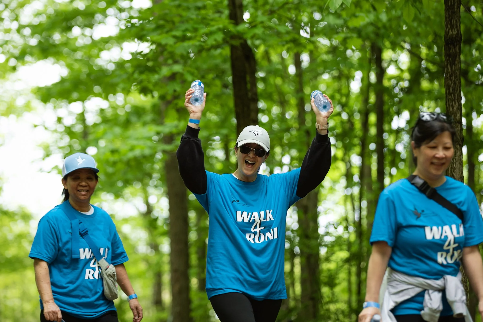 Volunteers laughing with pom poms