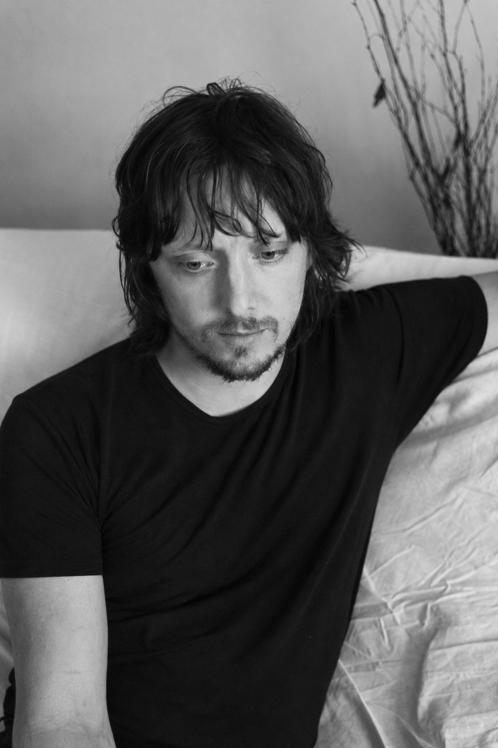 Kristian Marr, author of The App in Your Head, photographed in black and white sitting on a sofa.