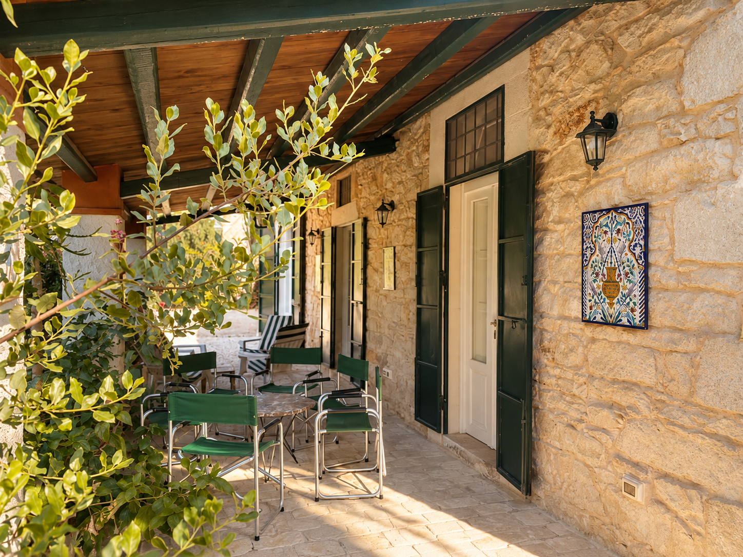 Stone patio with shaded outdoor seating at the Sicily coliving