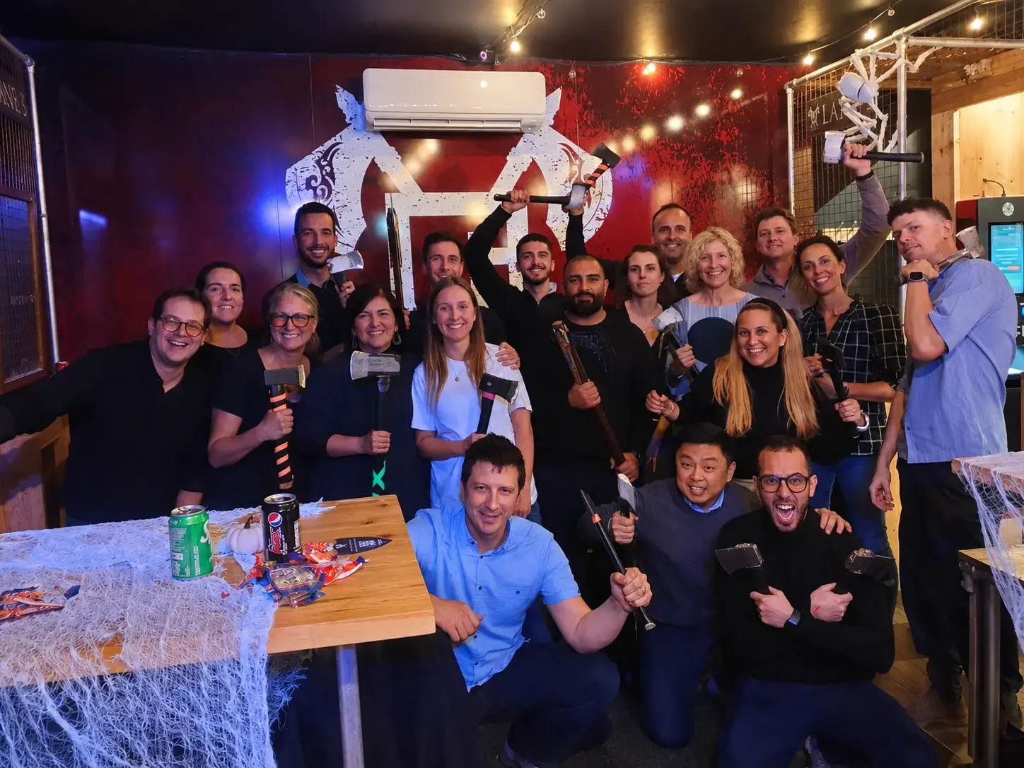 Corporate group celebrating after their axe throwing session