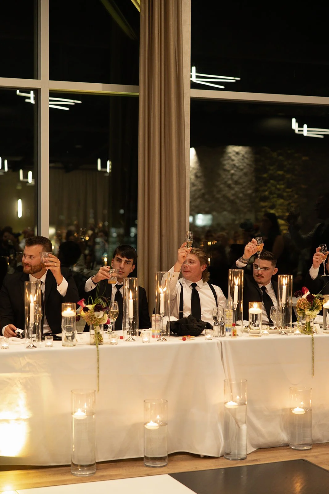 Low arrangements and candlelight along the head table, florals by Hydrangea Bloom, photographed by Madisen Timp Weddings